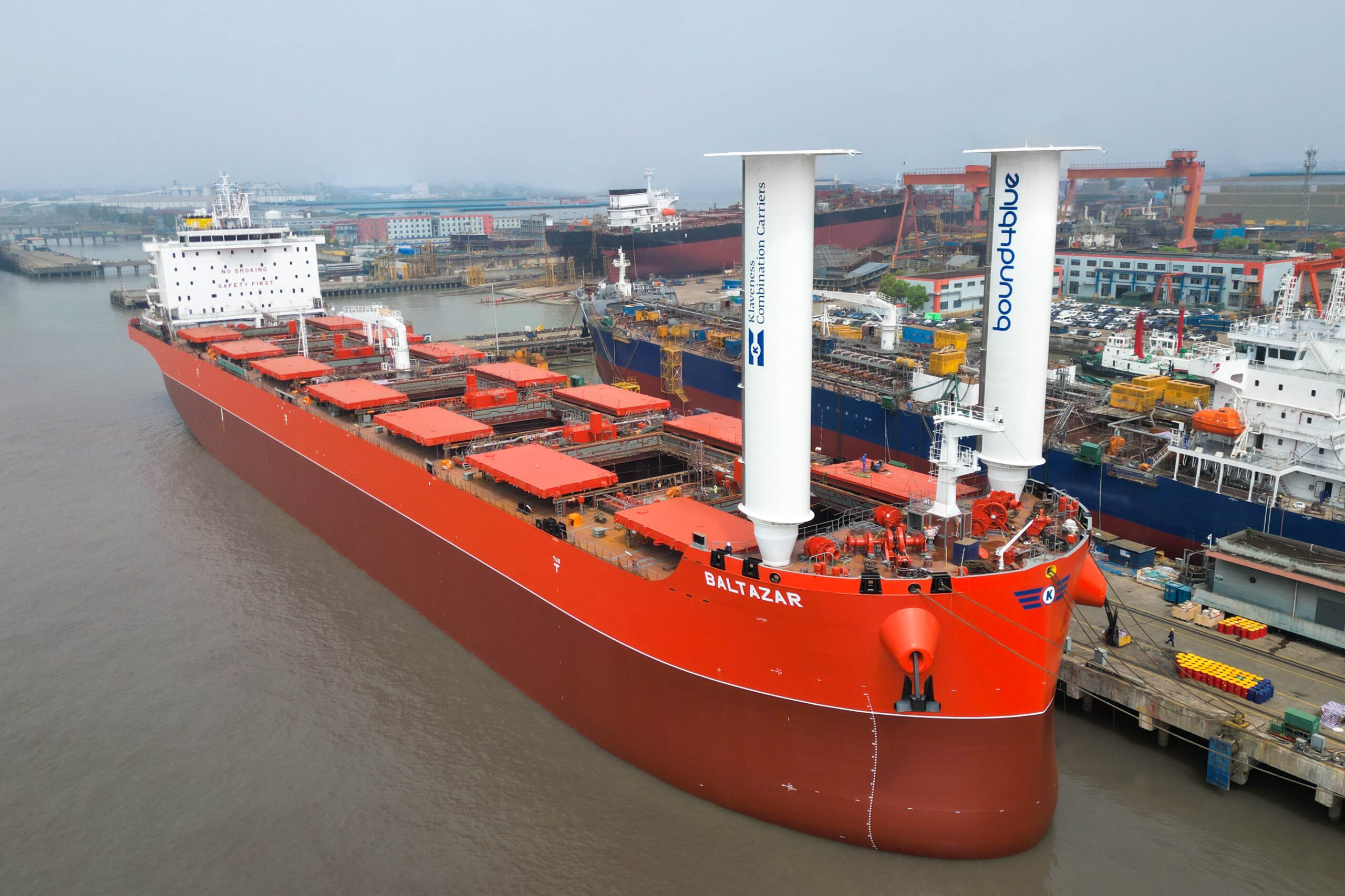 Installation of two 24-metre eSAIL® wind propulsion systems on MV Baltazar during newbuild construction at New Yangzi Shipbuilding, demonstrating suction sail technology for fuel savings and maritime decarbonisation.